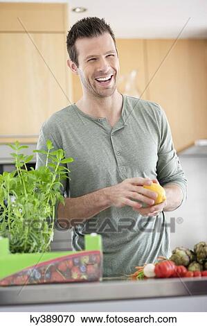 Man preparing food in the kitchen View Large Photo Image Stock Image - Man preparing food in the kitchen. Fotosearch