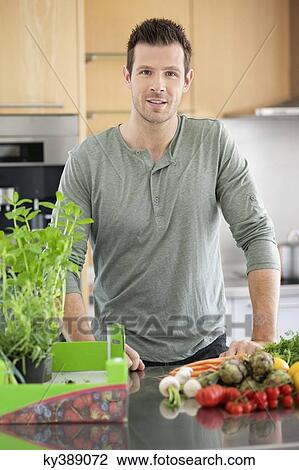 Man preparing food in the kitchen View Large Photo Image Stock Image - Man preparing food in the kitchen. Fotosearch