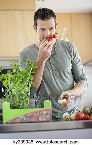 Man preparing food in the kitchen View Large Photo Image Stock Photo - Man preparing food in the kitchen. Fotosearch