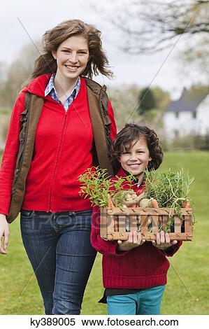 Mother and son with a crate of homegrown vegetables View Large Photo Image Stock Photography - Mother and son with a crate of homegrown vegetables. Fotosearch