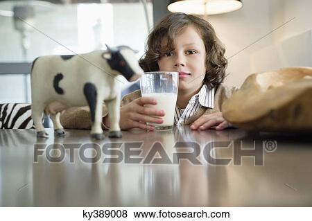 Portrait of a boy drinking a glass of milk View Large Photo Image Stock Photo - Portrait of a boy drinking a glass of milk. Fotosearch