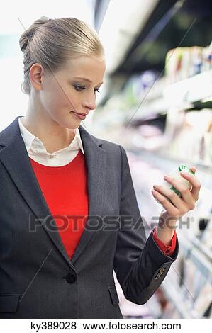 Stock Photo - Woman shopping in a supermarket. Fotosearch