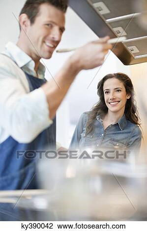 Couple tasting the food View Large Photo Image Stock Image - Couple tasting the food. Fotosearch