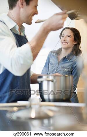 Couple tasting the food View Large Photo Image Stock Image - Couple tasting the food. Fotosearch