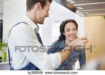 Stock Photo - Couple tasting the food. Fotosearch