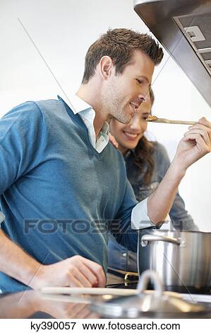 Stock Photo - Couple tasting the food. Fotosearch