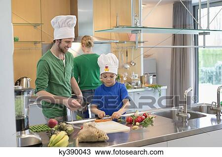 Family cooking in the kitchen View Large Photo Image Stock Image - Family cooking in the kitchen. Fotosearch