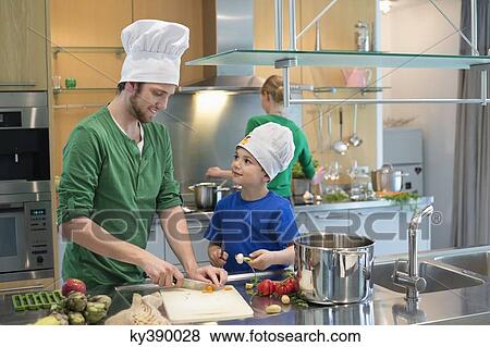 Family cooking in the kitchen View Large Photo Image Stock Photo - Family cooking in the kitchen. Fotosearch