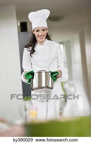 Female chef carrying a saucepan View Large Photo Image Stock Photo - Female chef carrying a saucepan. Fotosearch