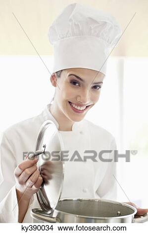 Happy female chef holding a saucepan View Large Photo Image Picture - Happy female chef holding a saucepan. Fotosearch
