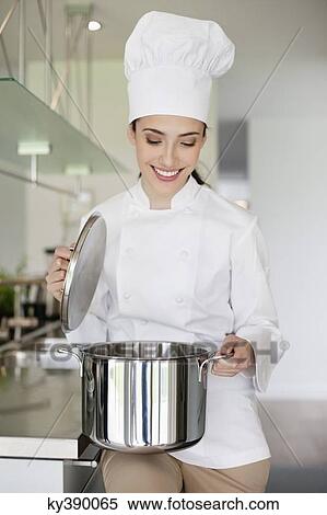 Happy female chef holding a saucepan View Large Photo Image Stock Photography - Happy female chef holding a saucepan. Fotosearch