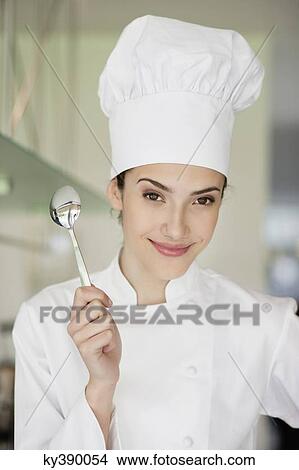 Happy female chef holding a spoon View Large Photo Image Picture - Happy female chef holding a spoon. Fotosearch