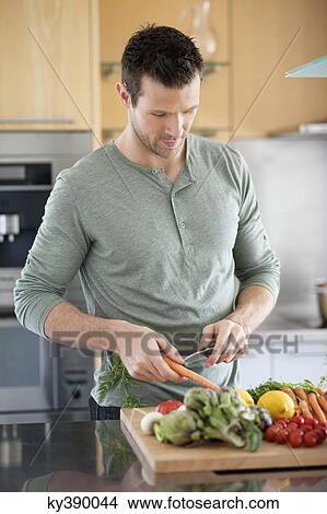 Man preparing food in the kitchen View Large Photo Image Picture - Man preparing food in the kitchen. Fotosearch