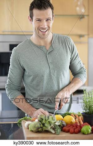Man preparing food in the kitchen View Large Photo Image Stock Image - Man preparing food in the kitchen. Fotosearch