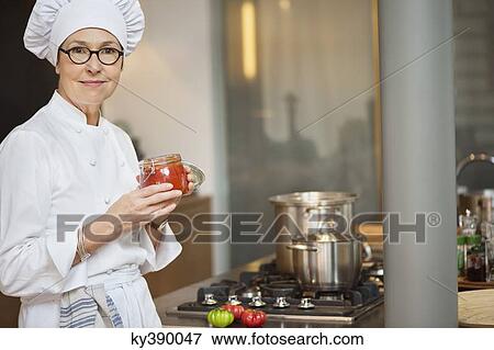 Woman holding a jar of tomato sauce View Large Photo Image Stock Photo - Woman holding a jar of tomato sauce. Fotosearch