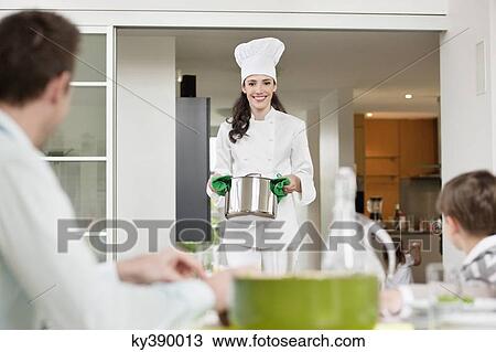 Woman serving food to her family View Large Photo Image Stock Image - Woman serving food to her family. Fotosearch