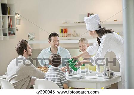 Woman serving lunch at dining table View Large Photo Image Stock Photography - Woman serving lunch at dining table. Fotosearch