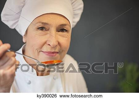 Woman tasting food View Large Photo Image Stock Photograph - Woman tasting food. Fotosearch