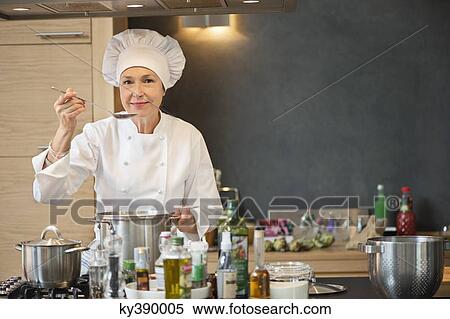 Stock Photography - Woman tasting food. Fotosearch
