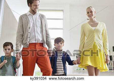 Picture - Couple walking with their children. Fotosearch