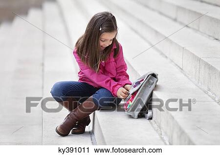 Girl opening her schoolbag View Large Photo Image Stock Image - Girl opening her schoolbag. Fotosearch