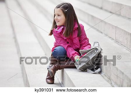 Girl opening her schoolbag View Large Photo Image Stock Image - Girl opening her schoolbag. Fotosearch