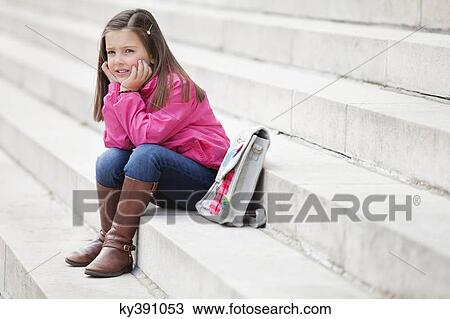 Girl sitting on the steps and thinking View Large Photo Image Stock Image - Girl sitting on the steps and thinking. Fotosearch