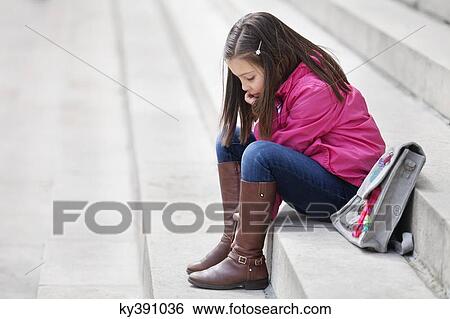 Girl sitting on the steps View Large Photo Image Stock Photograph - Girl sitting on the steps. Fotosearch