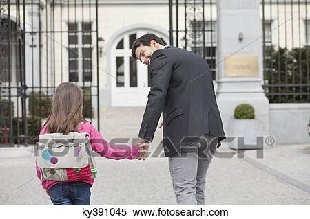 Girl walking towards school with her father View Large Photo Image Stock Photography - Girl walking towards school with her father. Fotosearch