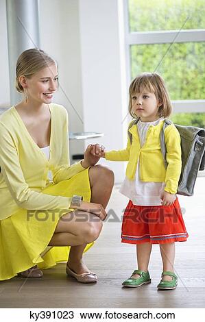 Stock Image - Little girl getting ready for school. Fotosearch
