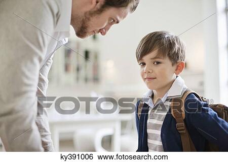 Man and his son with schoolbag View Large Photo Image Stock Photograph - Man and his son with schoolbag. Fotosearch