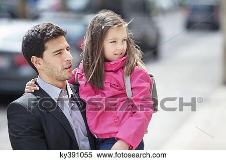 Man carrying his daughter View Large Photo Image Stock Photography - Man carrying his daughter. Fotosearch