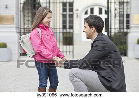 Stock Photograph - Man talking to his daughter. Fotosearch