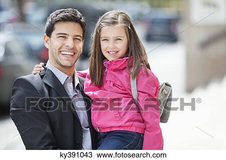 Portrait of a man carrying his daughter View Large Photo Image Stock Image - Portrait of a man carrying his daughter. Fotosearch