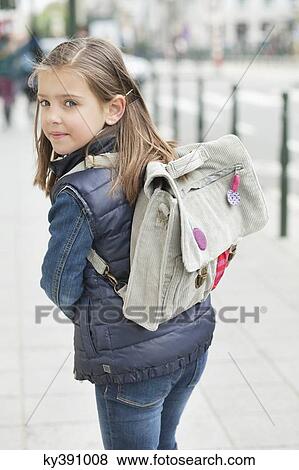 Schoolgirl walking on a footpath View Large Photo Image Stock Photo - Schoolgirl walking on a footpath. Fotosearch