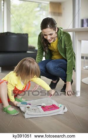Woman helping her daughter to get ready for school View Large Photo Image Stock Image - Woman helping her daughter to get ready for school. Fotosearch