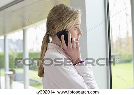 Businesswoman talking on a mobile phone View Large Photo Image Picture - Businesswoman talking on a mobile phone. Fotosearch