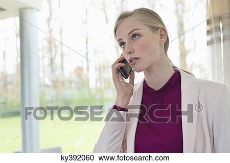Businesswoman talking on a mobile phone View Large Photo Image Stock Image - Businesswoman talking on a mobile phone. Fotosearch