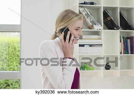 Businesswoman talking on a mobile phone View Large Photo Image Stock Photograph - Businesswoman talking on a mobile phone. Fotosearch