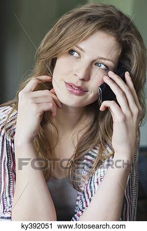 Stock Image - Close-up of a beautiful woman talking on a mobile phone. Fotosearch