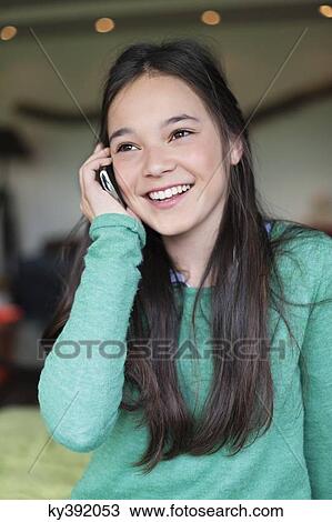 Girl talking on a mobile phone View Large Photo Image Stock Image - Girl talking on a mobile phone. Fotosearch