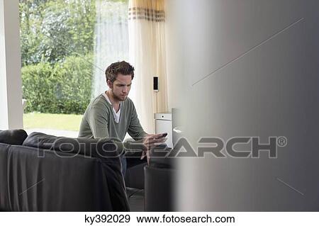 Stock Photo - Man holding a mobile phone. Fotosearch