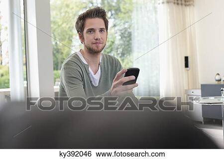 Man using a mobile phone View Large Photo Image Stock Photograph - Man using a mobile phone. Fotosearch