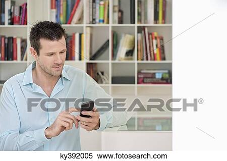 Stock Photography - Man using a mobile phone. Fotosearch