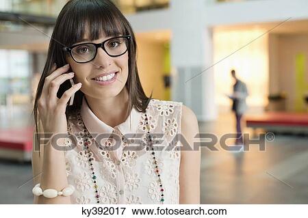 Stock Photo - Portrait of a businesswoman talking on a mobile phone. Fotosearch
