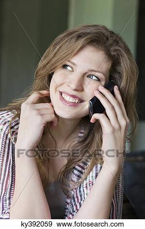 Woman talking on a mobile phone View Large Photo Image Stock Photo - Woman talking on a mobile phone. Fotosearch