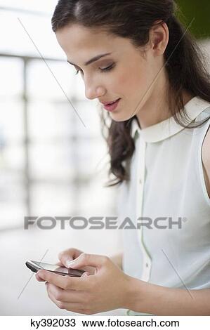 Stock Image - Woman using a smart phone. Fotosearch