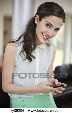 Woman using a smart phone View Large Photo Image Stock Image - Woman using a smart phone. Fotosearch