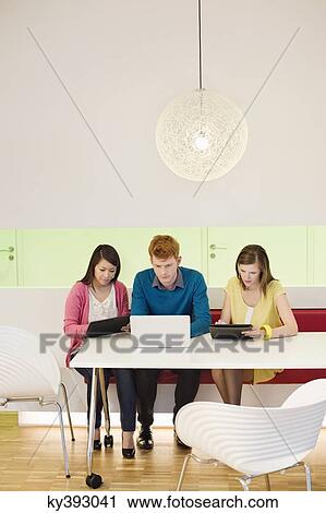 Business executives working in an office View Large Photo Image Stock Image - Business executives working in an office. Fotosearch
