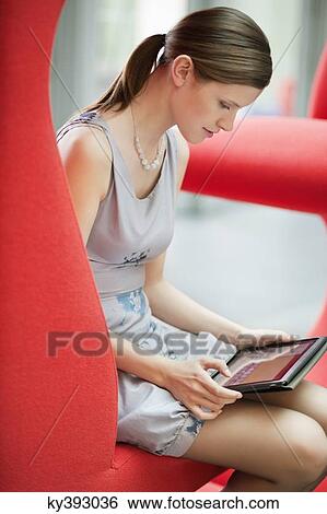 Businesswoman using digital tablet in an office View Large Photo Image Stock Photograph - Businesswoman using digital tablet in an office. Fotosearch
